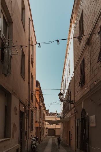 Photo of a Person in the Middle of Narrow Alley In Between Buildings