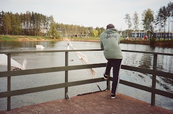 Photo of a Person Standing in Front of a Lake