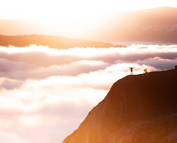 Photo of a Person Standing in Mountain