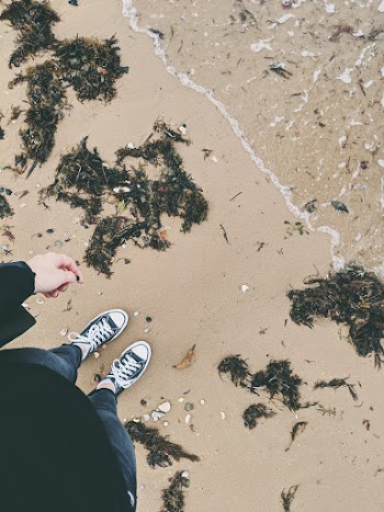 Photo of a Person Standing Near Body of Water