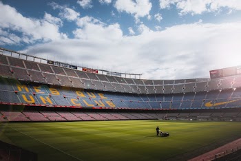 Photo of a Person Standing on Football Field
