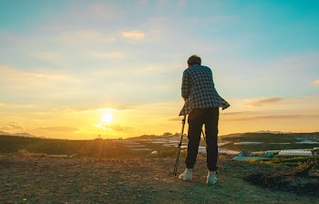 Photo of a Person Taking Photograph of Sun