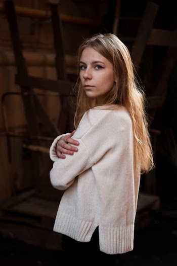 Photo of a Standing Woman with Her Arms Crossed