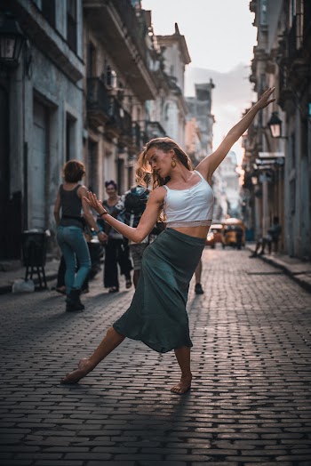 Photo of a Woman Dancing on a Street