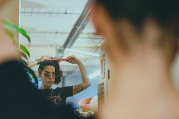 Photo of a Woman Fixing Her Hair