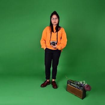 Photo of a Woman Holding a Camera