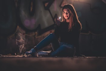 Photo of a Woman Holding a Lighter 