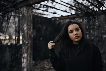 Photo of a Woman Holding Her Hair