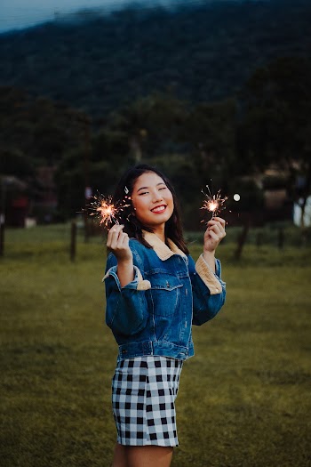 Photo of a Woman Holding Sparklers