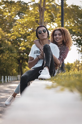 Photo of a woman hugging man from behind him