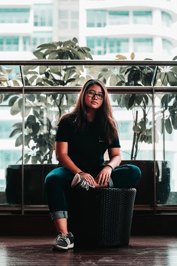 Photo of a Woman in Black Shirt Sitting