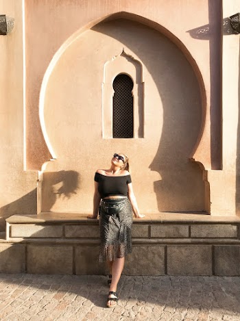 Photo of a Woman in Black Top and Black Skirt