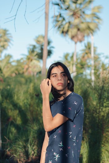 Photo of a Woman in Blue T-Shirt Standing Outdoors 
