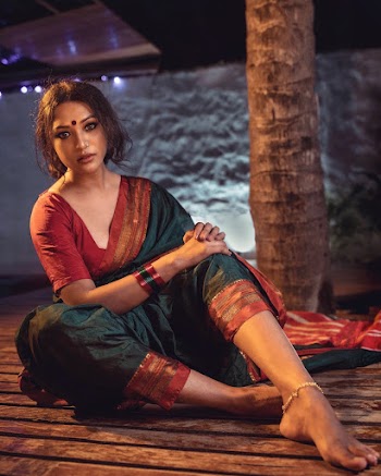 Photo of a Woman in Red and Green Sari Dress