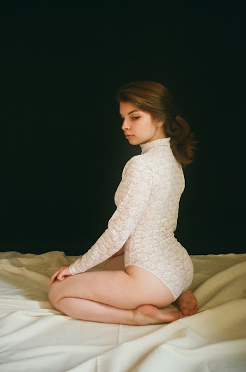 Photo of a Woman in White Lace One-piece Bodysuit 