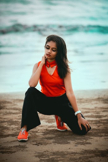 Photo Of A Woman Kneeling on Brown Sand