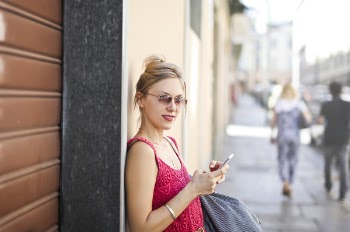Photo of a Woman Leaning on a Wall