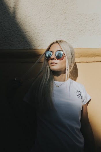 Photo of a Woman Leaning on Wall