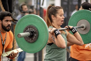 Photo of a Woman Lifting a Barbell 