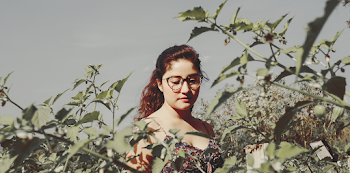 Photo of a Woman Looking at Plants