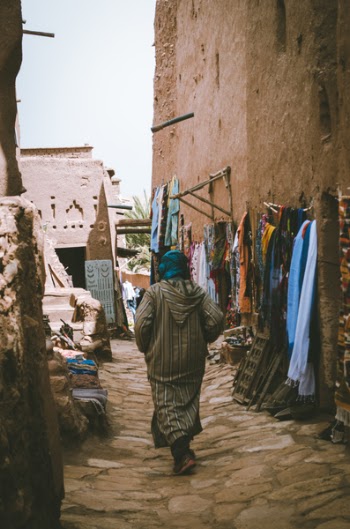 Photo of a Woman Passing Through the Alley 