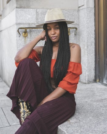 Photo of a Woman Sitting in Front of Door