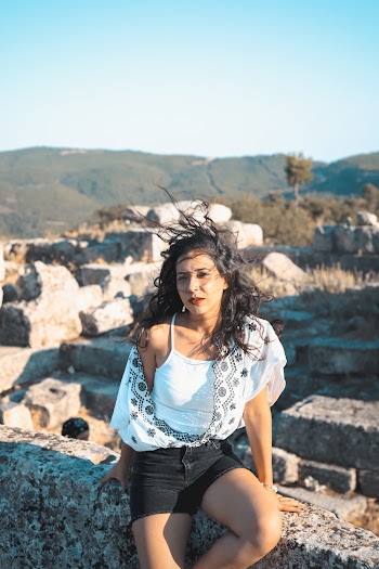 Photo of a Woman Sitting on Concrete Block