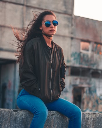 Photo of a Woman Sitting on Ledge