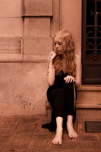 Photo of a Woman Sitting on Outside Stairs 