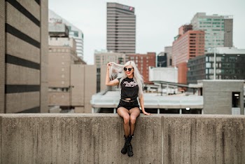 Photo of a Woman Sitting on Wall