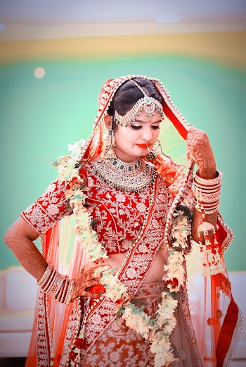 Photo of a Woman Standing  in Pink  Sari Dress
