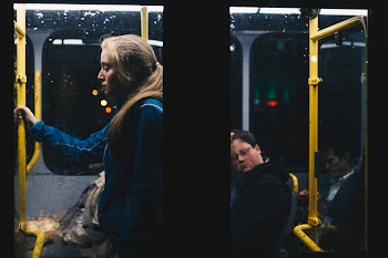 Photo of a Woman Standing Inside Bus