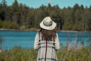 Photo of a Woman Standing Near Body of Water