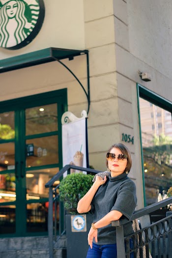Photo of a Woman Standing Near Starbuck Cafe