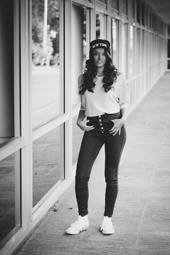 Photo of a Woman Standing near the Window Glass