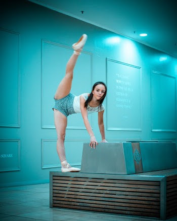 Photo of a Woman Stretching on Chair