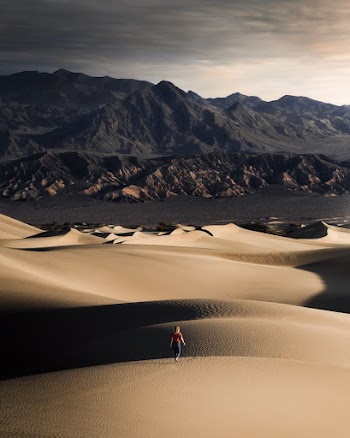 Photo of a Woman Walking on Desert