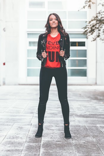 Photo of a Woman Wearing Black Jacket and Leggings