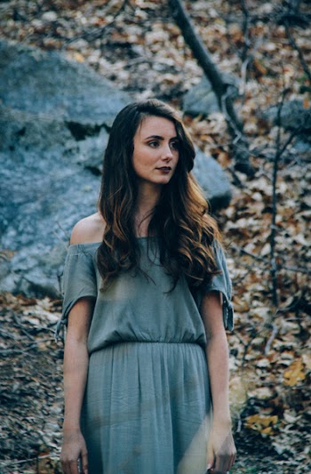 Photo of a Woman Wearing Blue Off-shoulder Dress