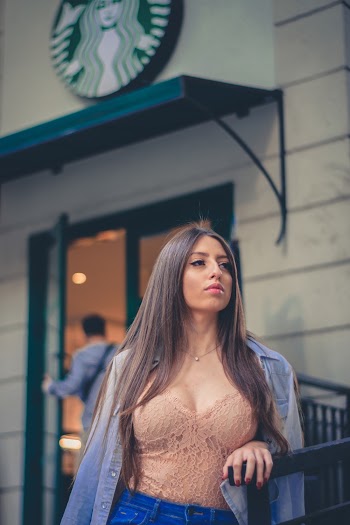 Photo of a Woman Wearing Peach Top and Blue Jacket