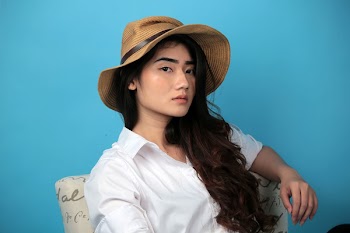 Photo of a Woman Wearing Straw Hat