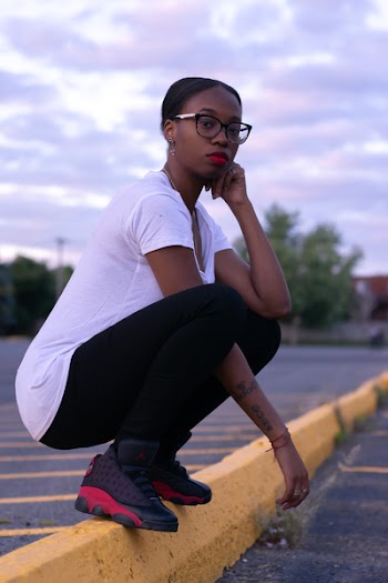 Photo of a Woman Wearing White Shirt and Black Pants