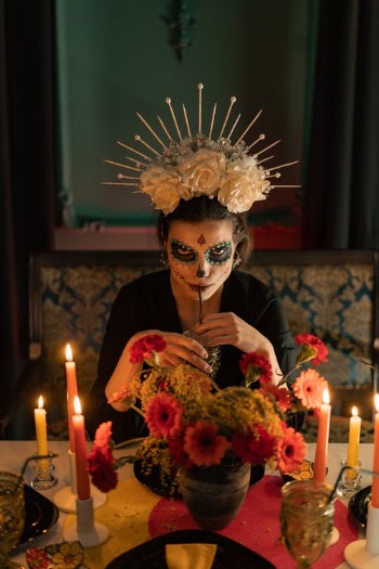 Photo of a Woman with Face Paint Drinking from a Straw · Free Stock Photo