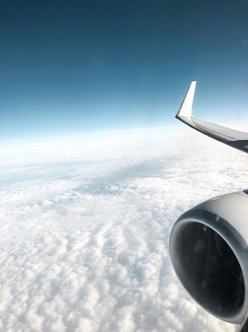 Photo of Airplane Flying Above Clouds