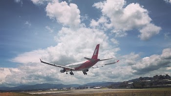 Photo of Airplane Over Runway