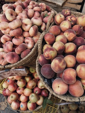 Photo of Apples and Peaches on Wicker Baskets