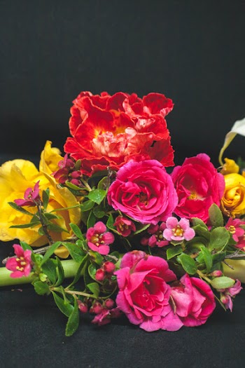 Photo of Assorted Flowers on Black Surface
