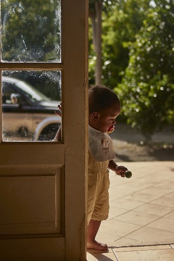Photo of Baby Boy With Pacifier and Bib