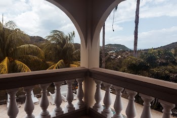 Photo of Balcony Across Trees Under Cloudy Sky