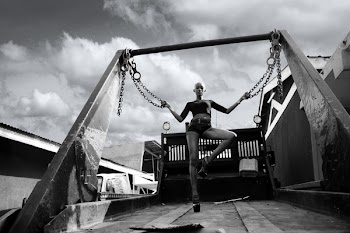 Photo of Bald Woman Holding Two Chains